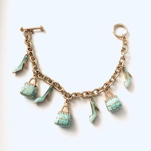 Gold charm bracelet with toggle clasp and shoes, handbag charms